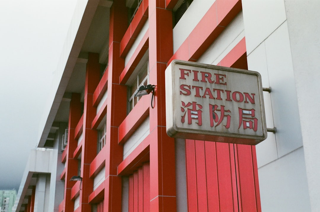 Fire station sign on red and white building.
