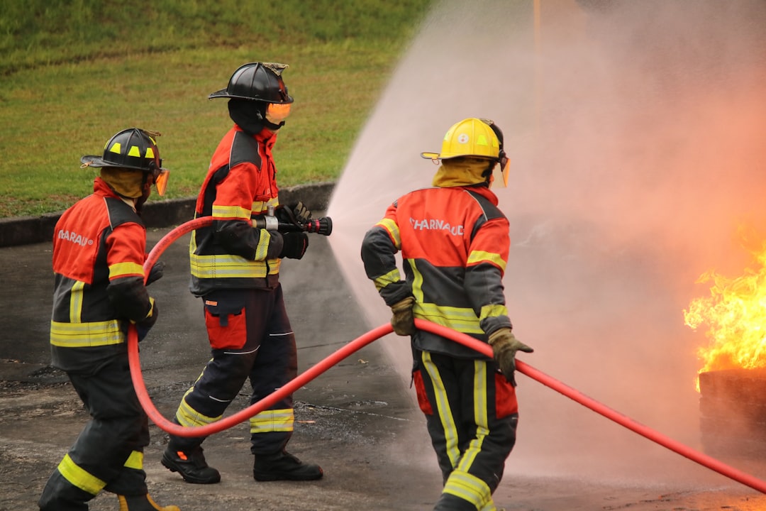 Firefighters extinguish a blaze with water hoses.