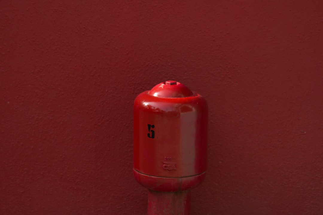 red metal tool on red surface