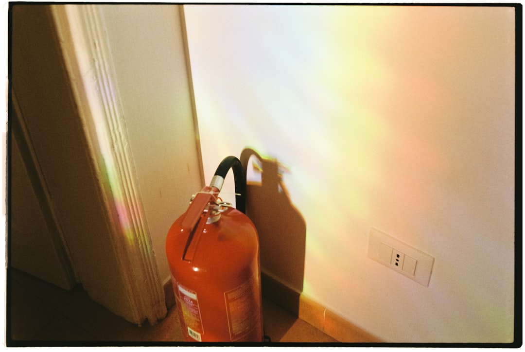 A fire extinguisher sitting in front of a door