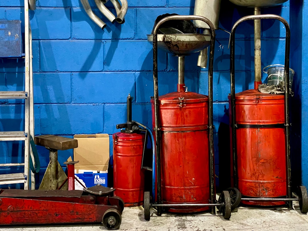 A bunch of red luggage sitting next to a blue wall