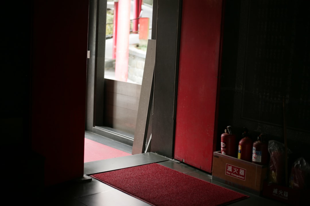 Red doors and fire extinguishers near entrance.