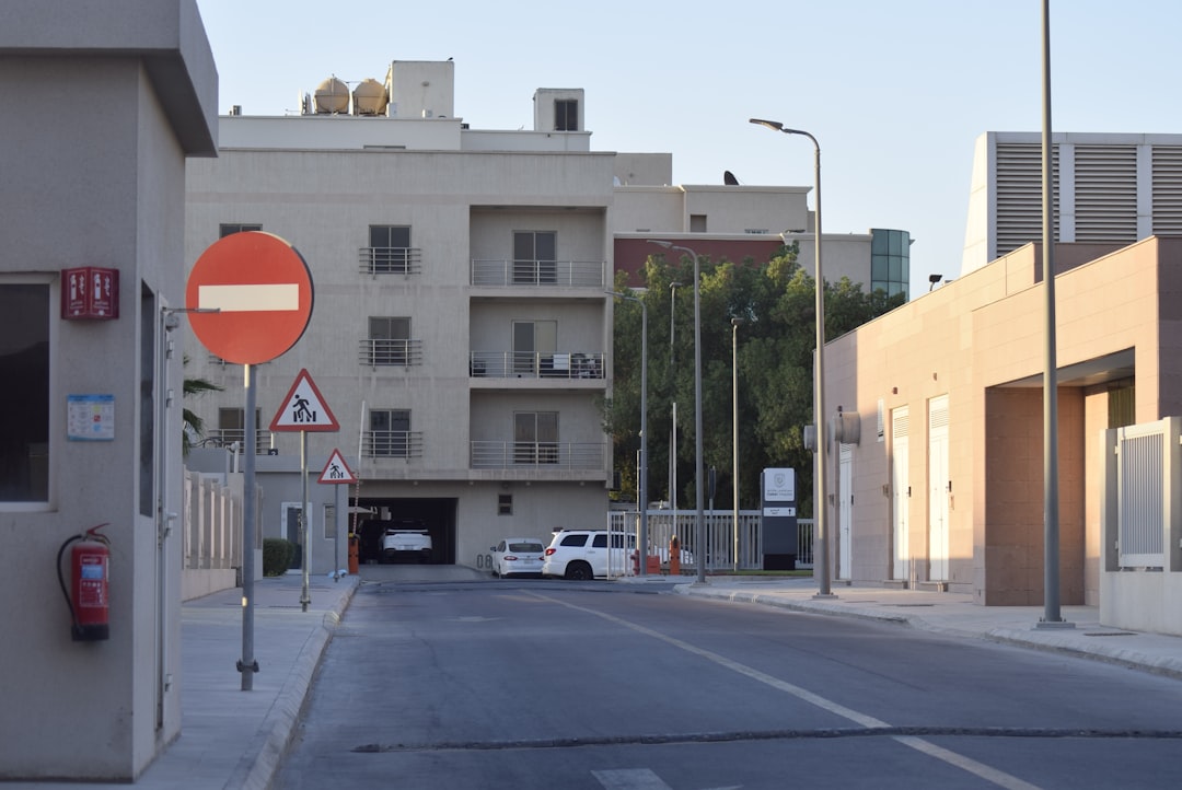 Street with buildings, signs, and a white truck.