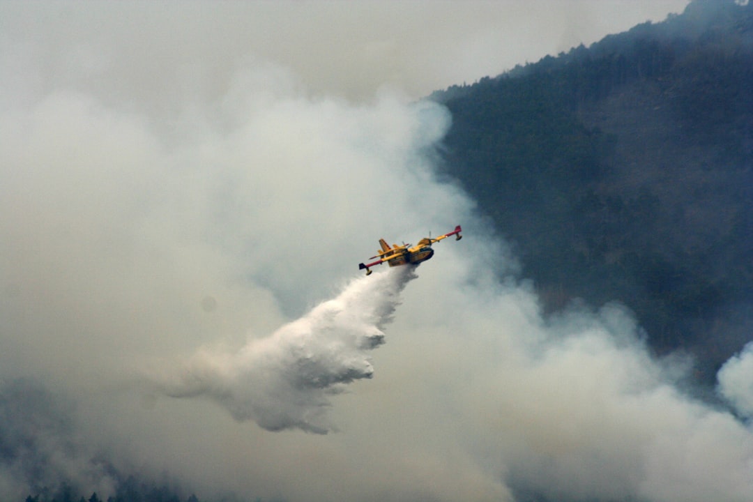 a plane flying through a cloud of smoke